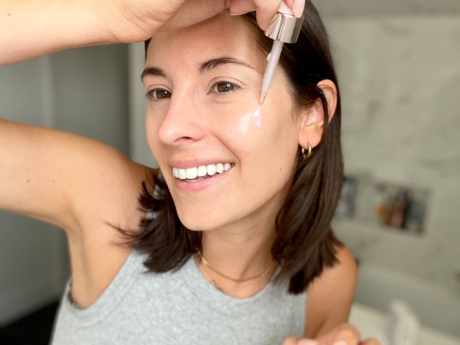 woman applying olay serum