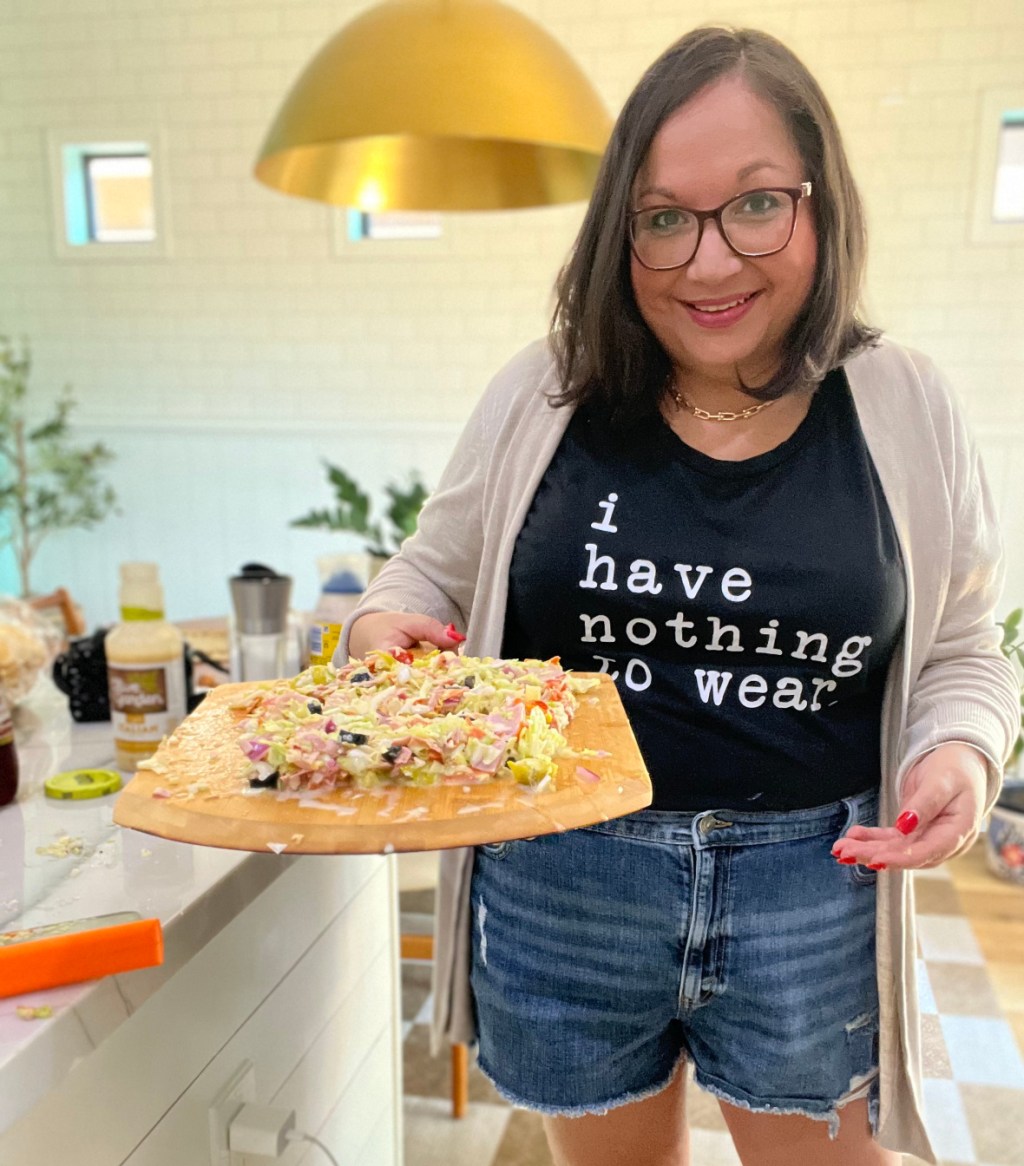 woman holding chopped Italian sandwich filling