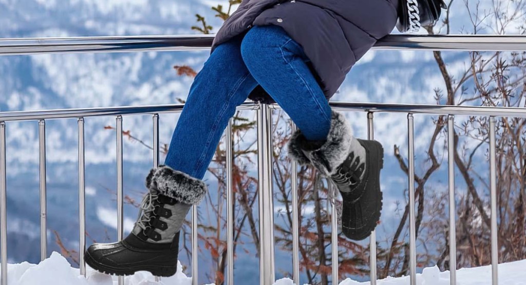 woman wearing winter duck boots while siting down