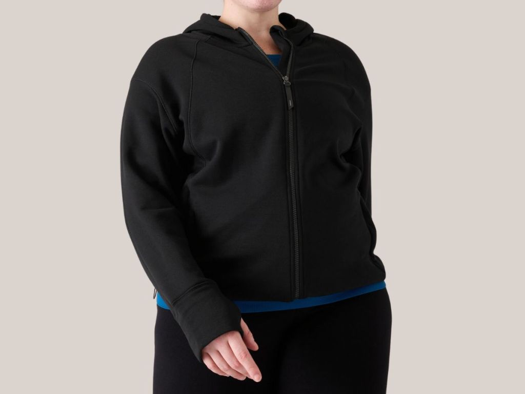 woman wearing a black Athleta jacket