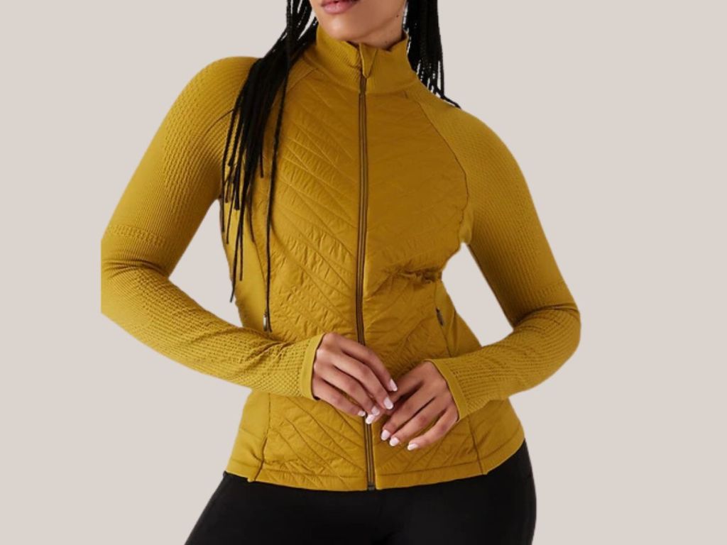 woman wearing a mustard gold color Athleta Jacket