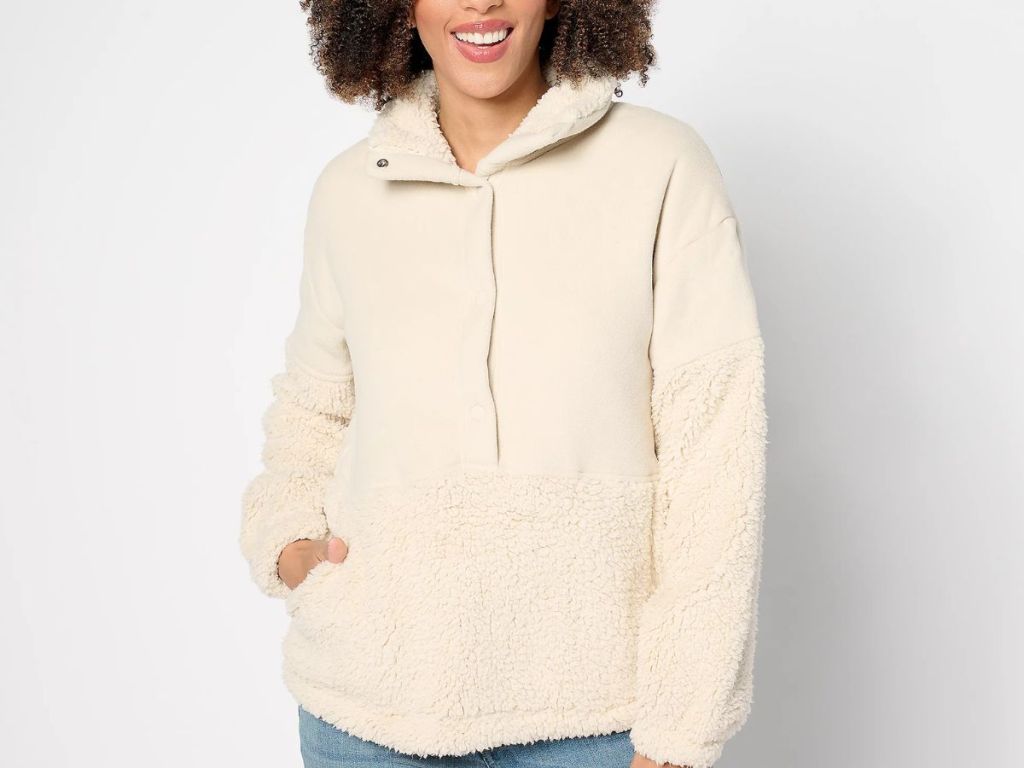 woman wearing a cream color sherpa pullover