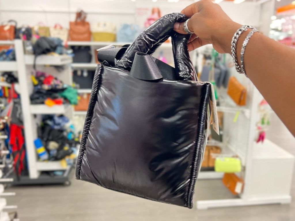 a womans hand displaying A New Day Midi Boxy Satchel Handbag in Black