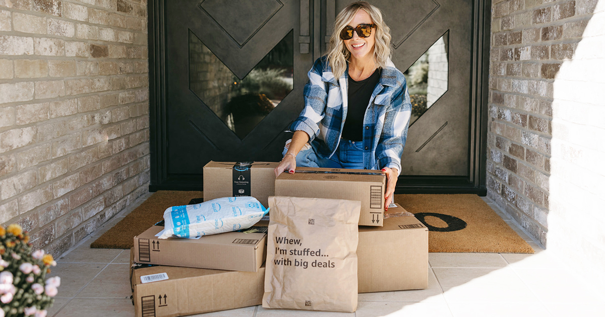 woman sitting on porch with lots of amazon boxes