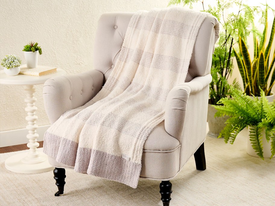 grey and white striped blanket on accent chair