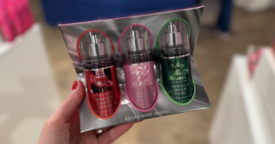Hand holding a bath & body works fragrance mist trio