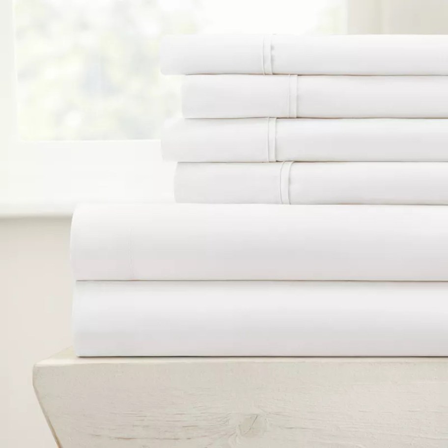 stack of white sheets in front of window