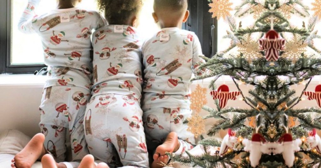 3 kids wearing matching burts bees christmas pajamas