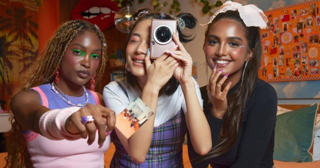 3 girls using a Canon Ivy Cliq2 photo printer camera