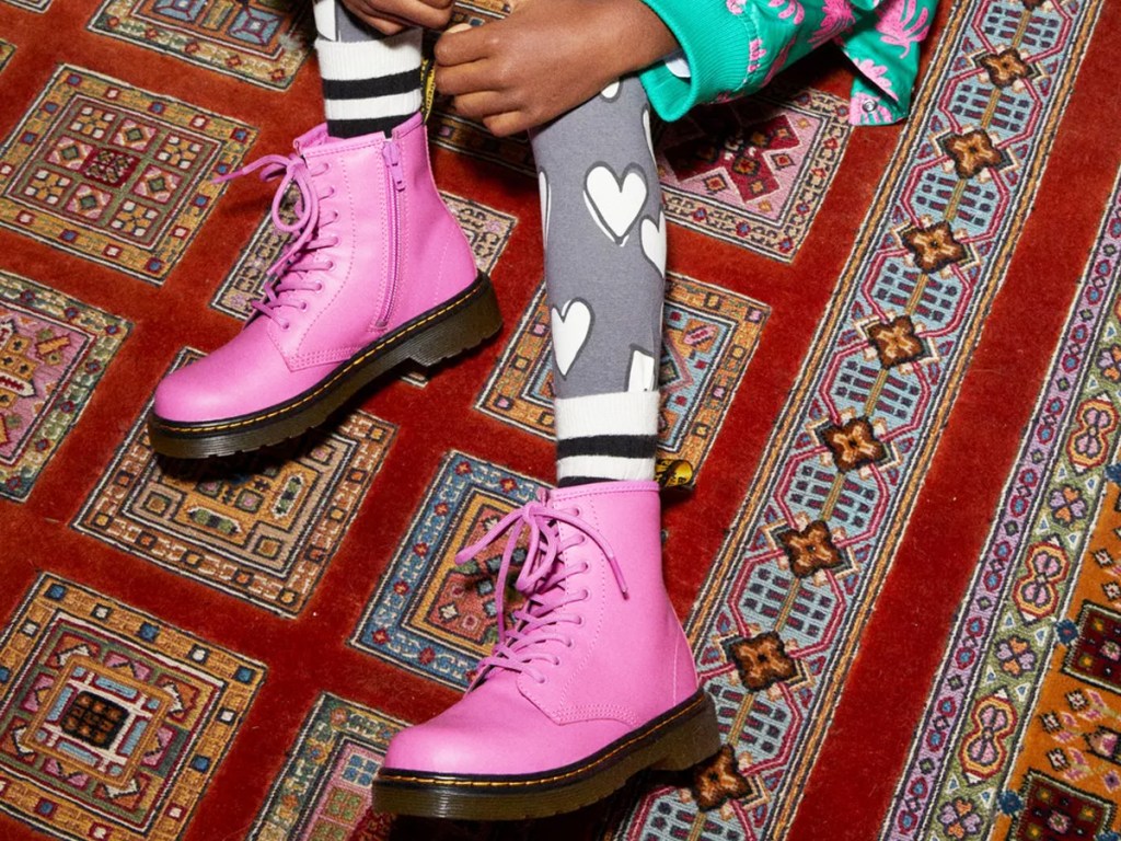 girl sitting on floor wearing bright pink onlinebat boots