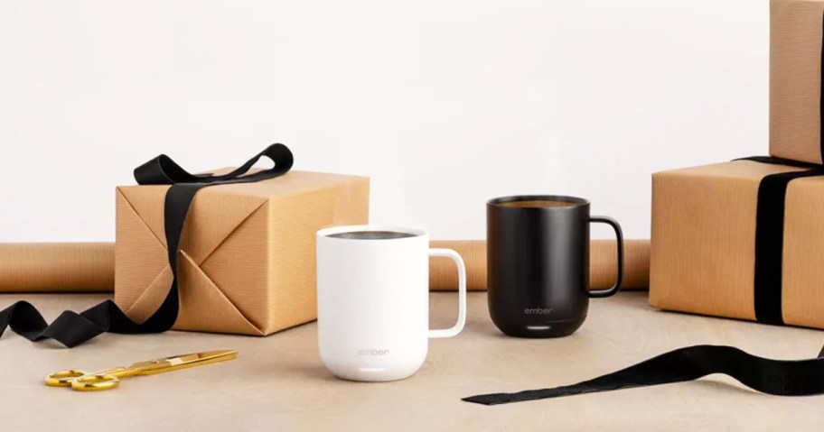 white and black ember coffee mugs near wrapped boxes