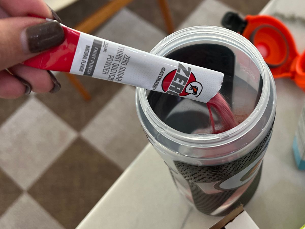 Gatorade bottle with powder packet being poured into it