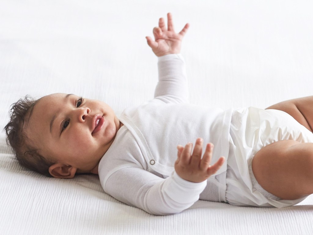 baby in a white long sleeve tee with side snaps