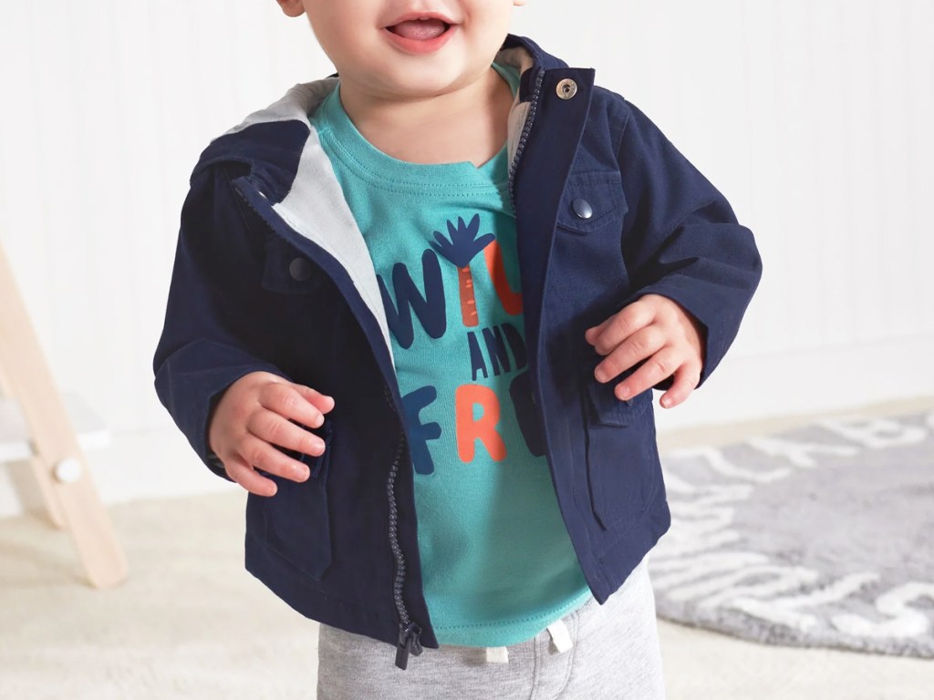 toddler wearing a blue graphic tee with a navy blue jacket