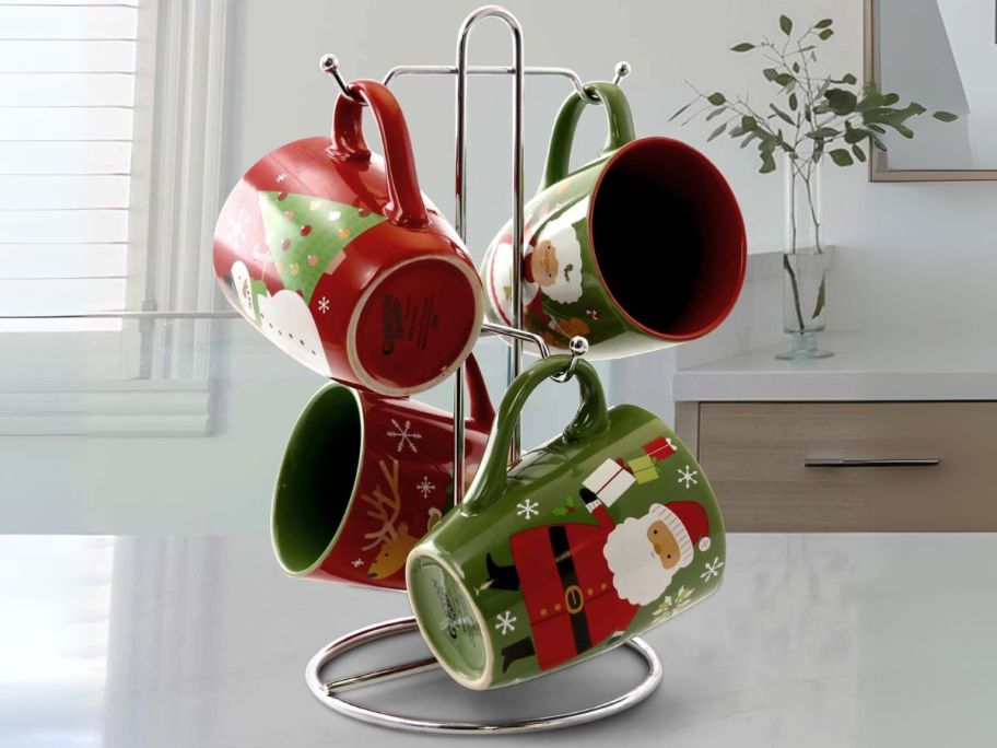 Gibson Home Santa Smile 15oz Stoneware Mugs 4-Piece Set w/ Metal Rack on counter