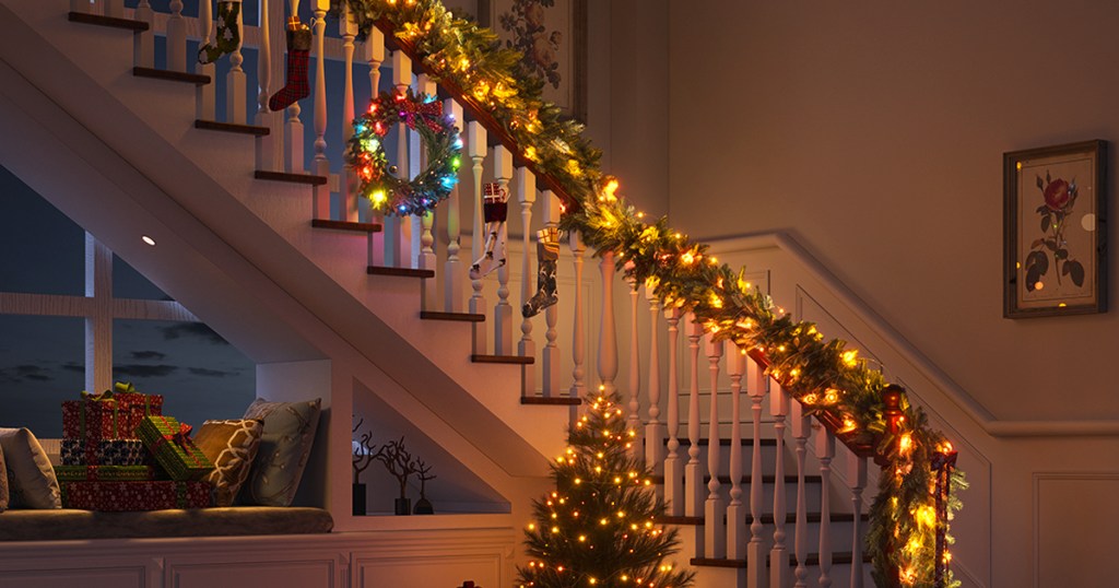 christmas tree, wreath, and garland on stairs light up with christmas lights