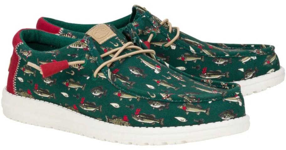 men's heydude Christmas shoes in green with fish on them wearing santa hats