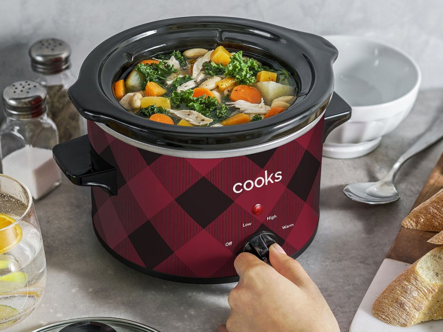 Holiday Slow Cooker in buffalo check displayed next to the table