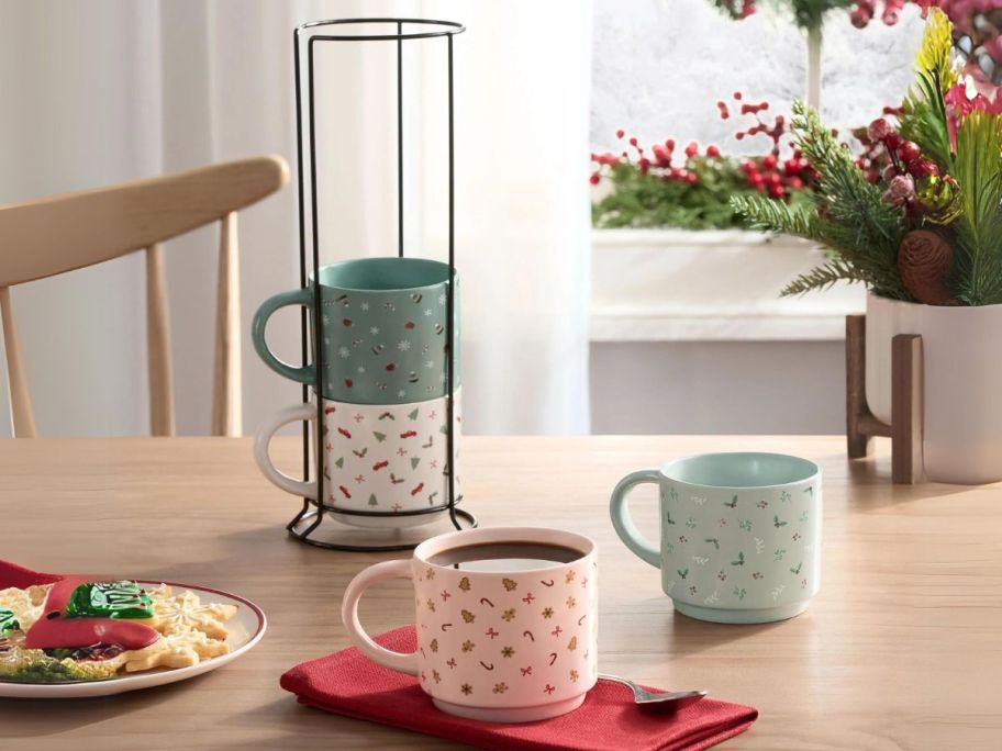 Holiday Time 11oz Holiday Ditsy Print Glazed Stoneware Ceramic Stacking Mug Set w/ Metal Rack on table