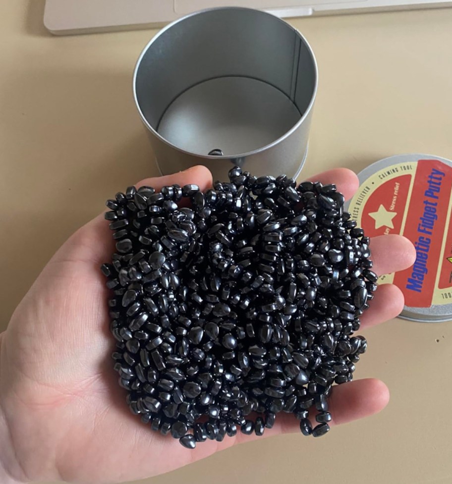 hand holding a pile of magnetic balls