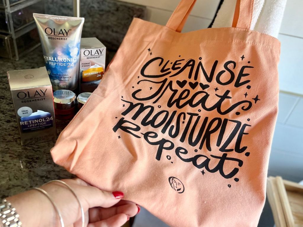 An olay tote bag next to several olay skincare products