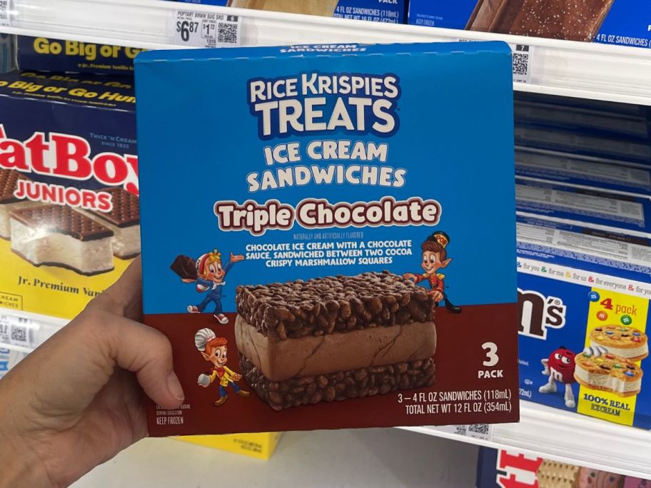 Hand holding a box of Rice Krispies Treats Ice Cream Sandwiches 3-count in Triple Chocolate Flavor
