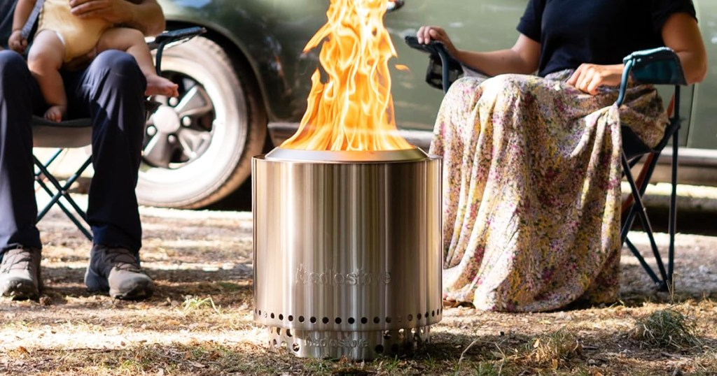 people sitting around solo stove fire pit