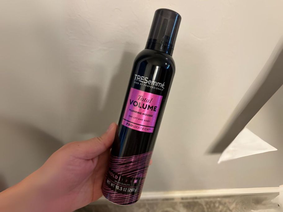 hand holding Tresemme Mousse bottle