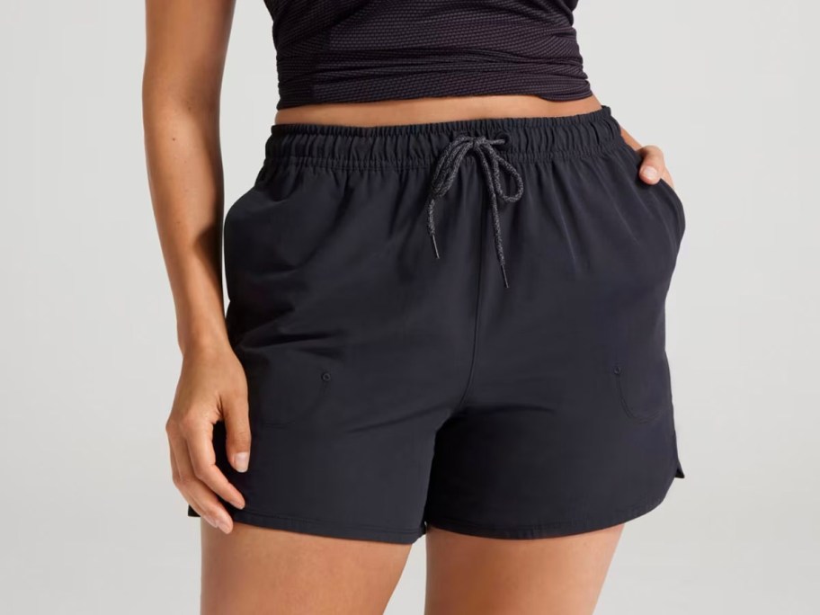 woman wearing black tee and allbirds shorts