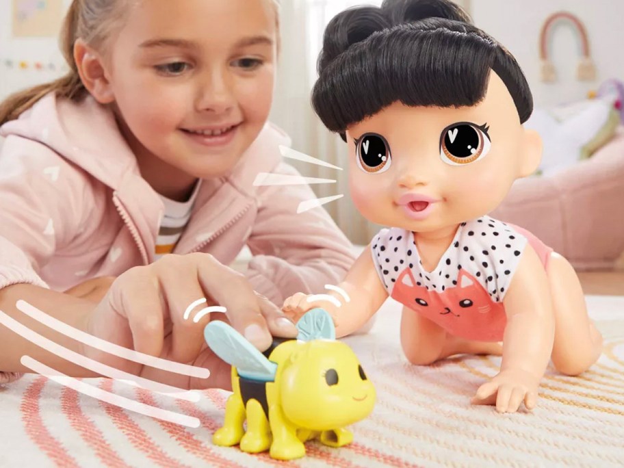 child playing with baby alive doll and bee toy