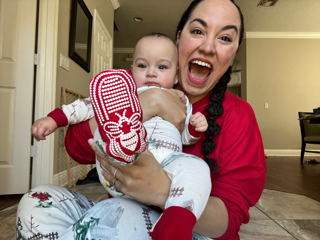 baby & mom in burts bees holiday pajamas sitting on floor