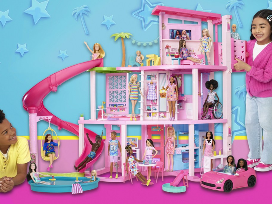 two kids playing with barbie dreamhouse with slide 