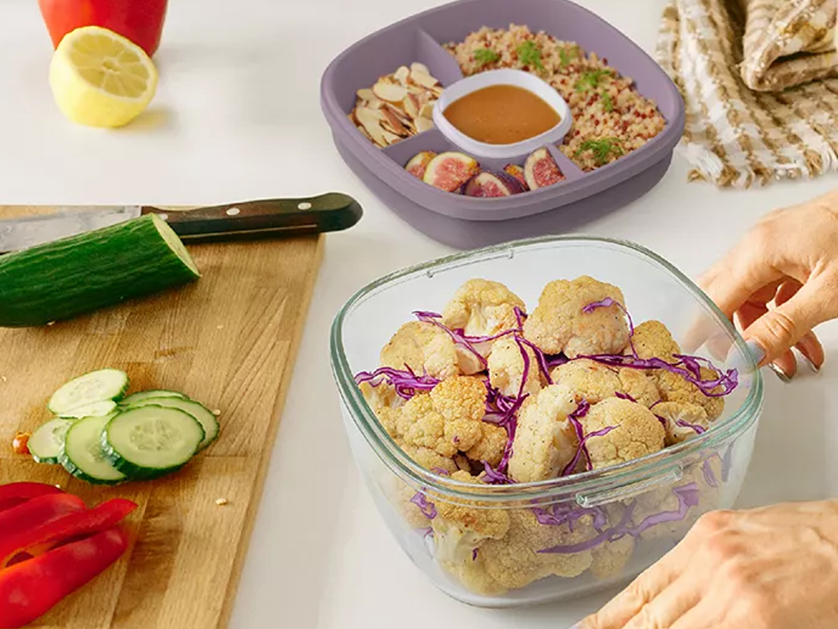 woman filling salad container with veggies