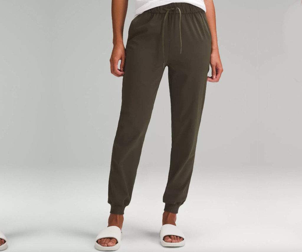 woman in dark olive green lululemon joggers