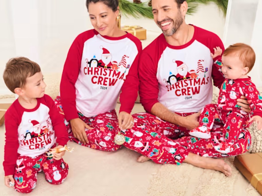 family wearing matching red and white Christmas pajamas that say "Christmas Crew"