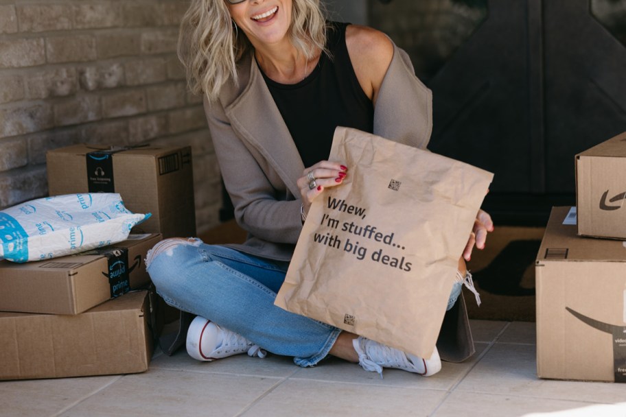 woman holding amazon package on front porch