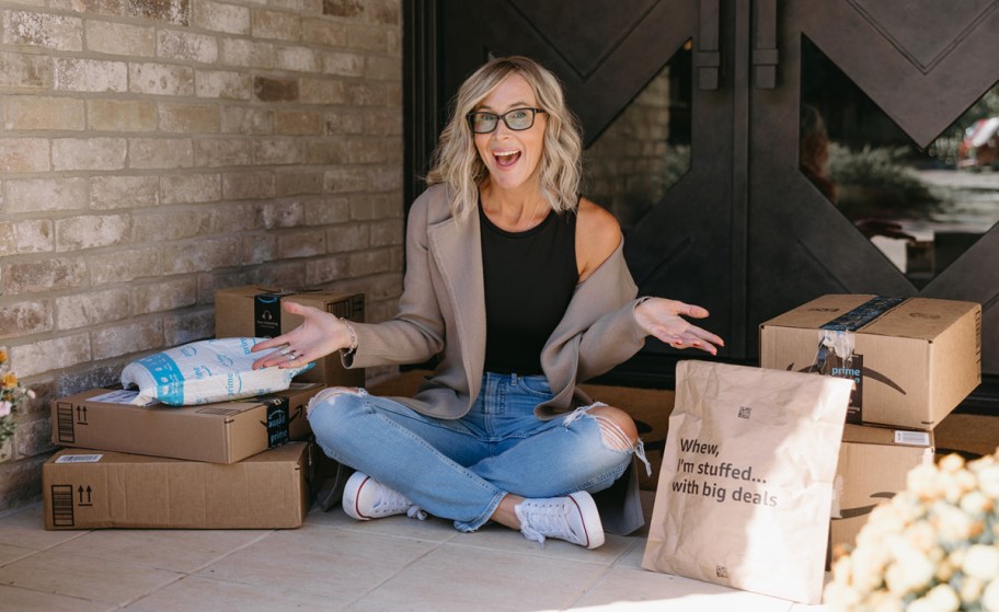 woman sitting next to amazon packages