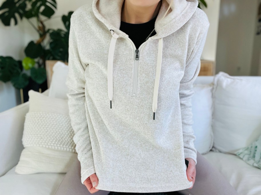 woman wearing cream zip up sweatshirt