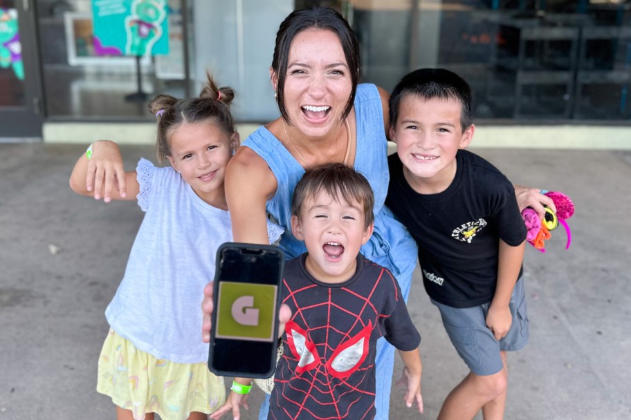 family with excited face holding phone with get out pass