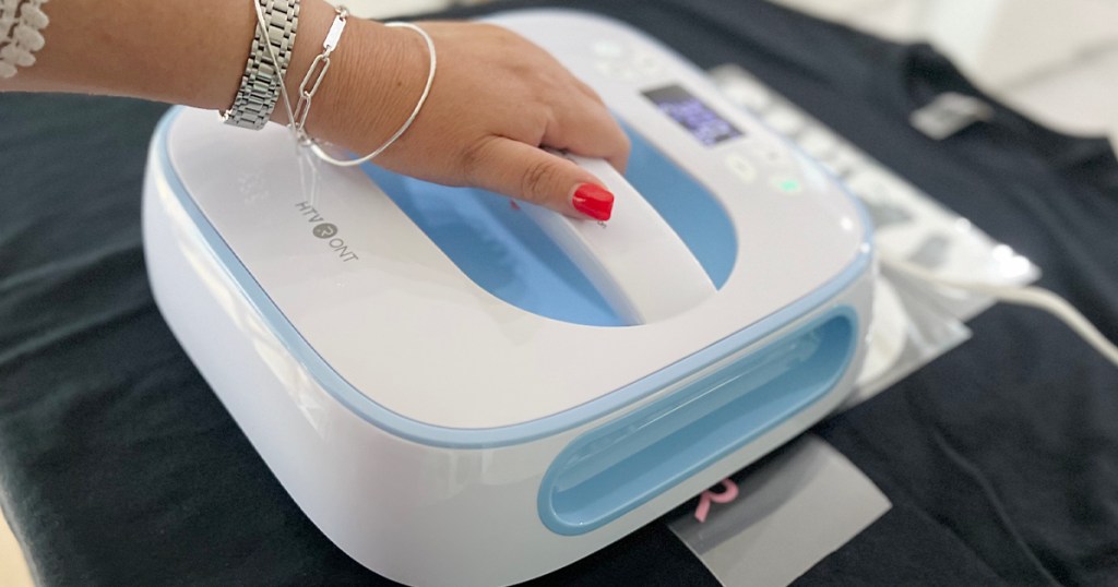 woman using heat press on tshirt