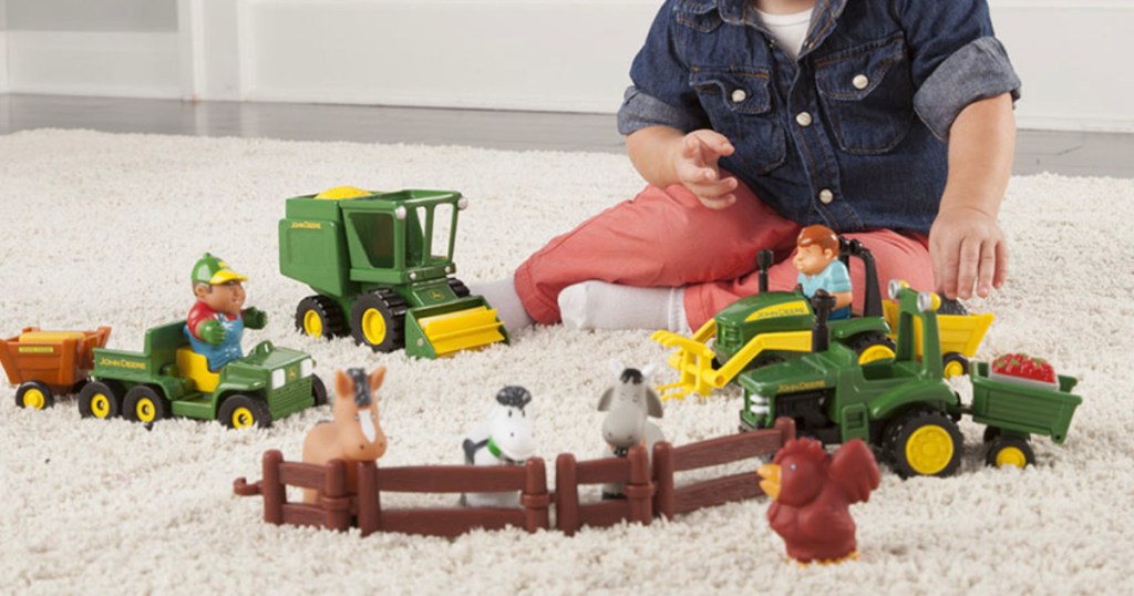 boy playing with john deere toys