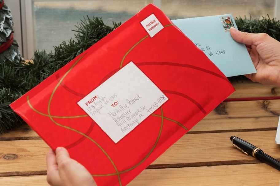 placing letters to and from santa in an envelope