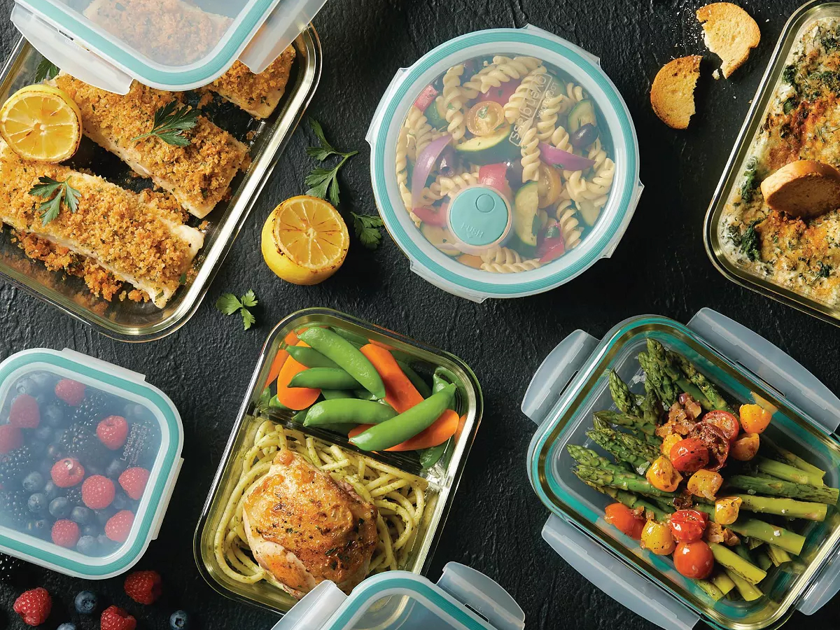 glass and teal lid food storage set on counter full of food