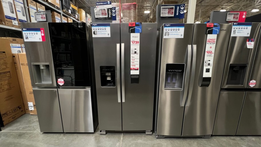 three refrigerators lined up next to each other on display at lowes