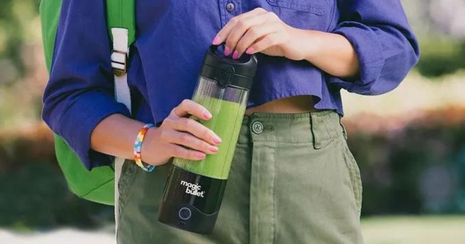 Woman holding a Magic Bullet Portable Blender