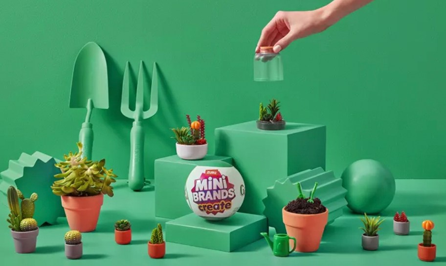 Mini brands garden toys on display with hand reaching for one