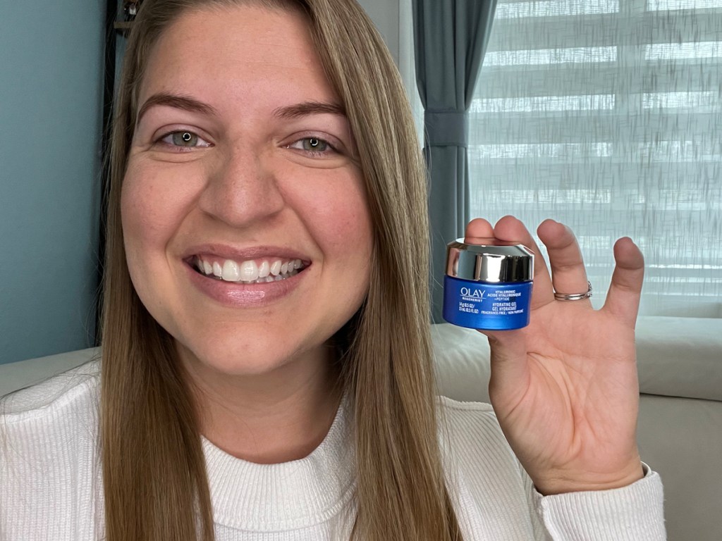 woman holding hyaluronic peptide cream