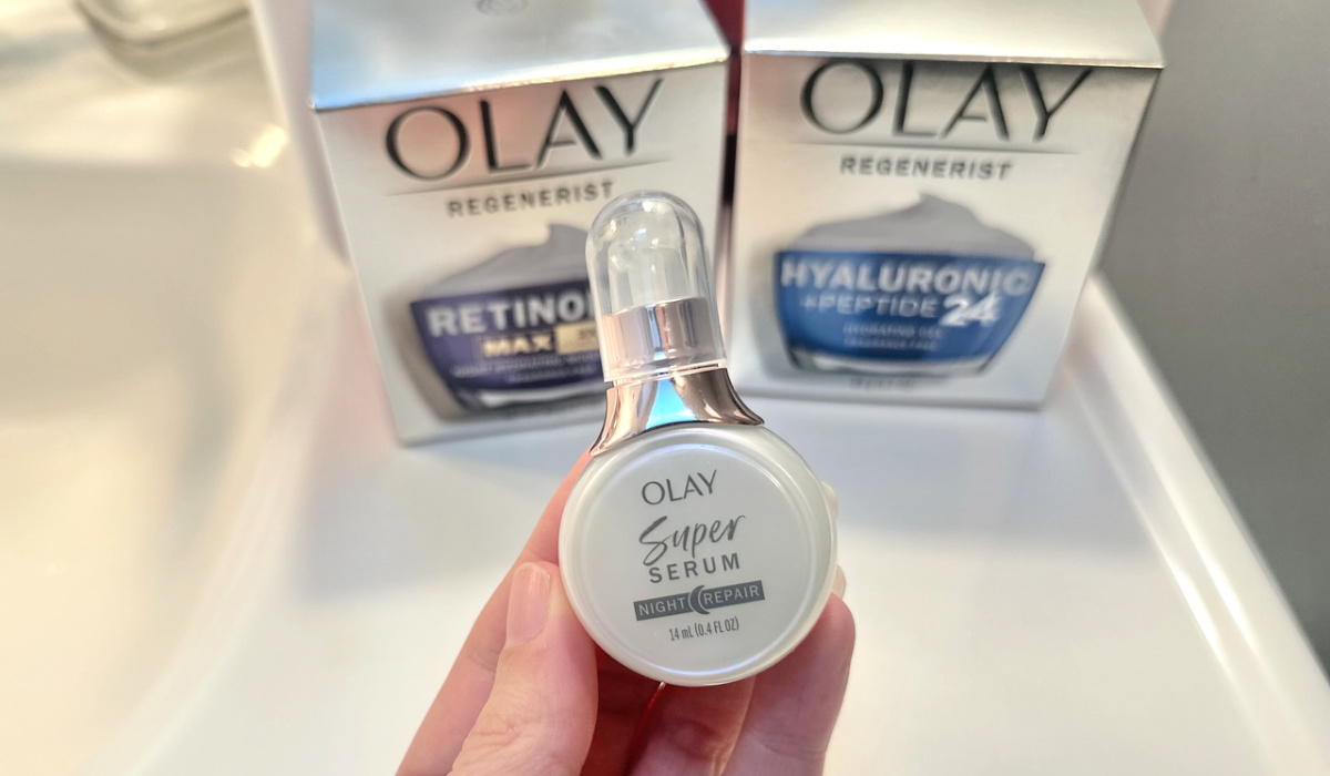 woman holding olay super serum