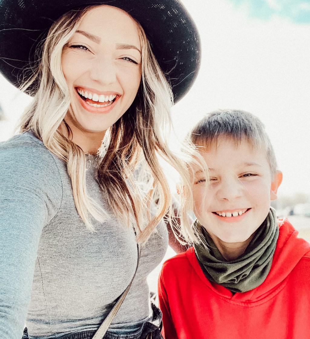 woman and boy standing next to each other