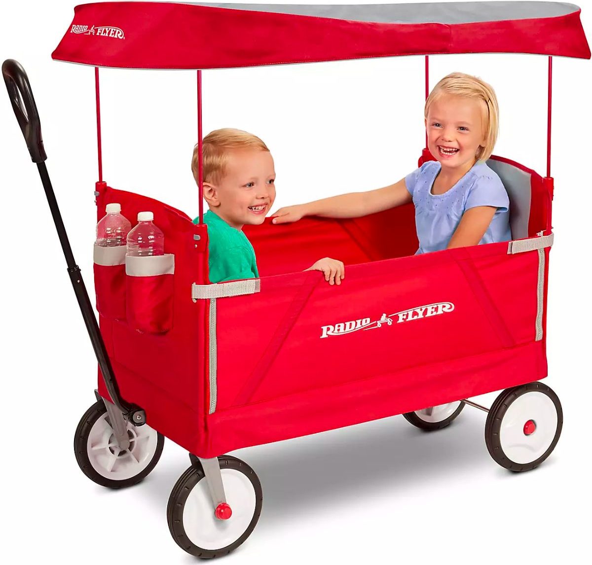 two little kids sitting in a red radio flyer kids wagon